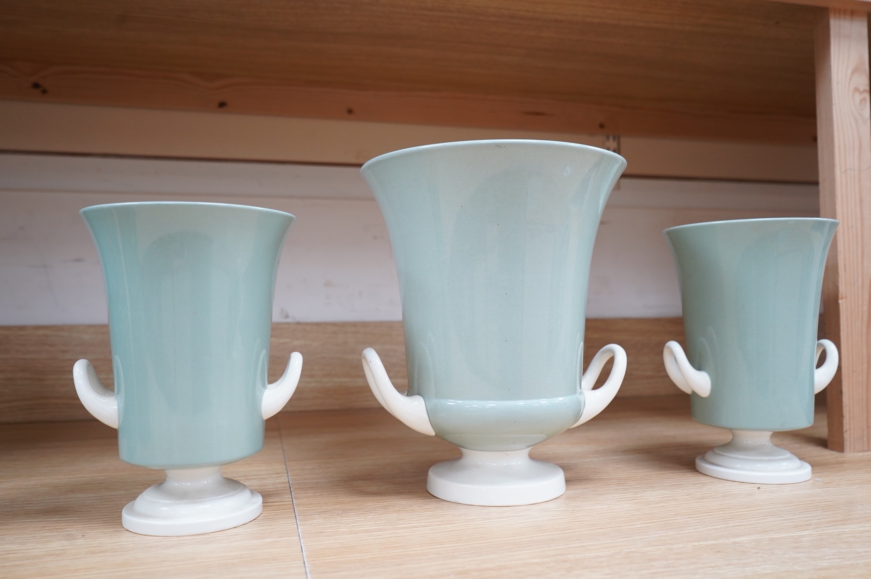 Keith Murray for Wedgwood, a garniture of three graduated twin handled slipware vases, stamped to the bases, largest 25cm high